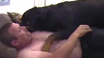 Big man gives blowjob to rottweiler